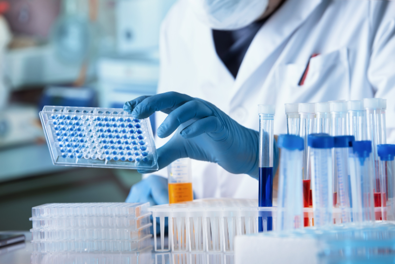 Scientist with pipettes in a lab 