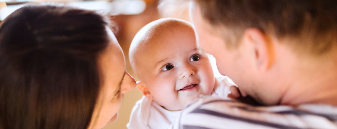 Happy baby smiling at parents