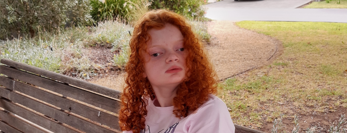 Emma sitting on a park bench