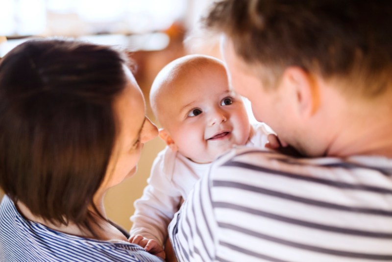 Happy baby smiling at parents