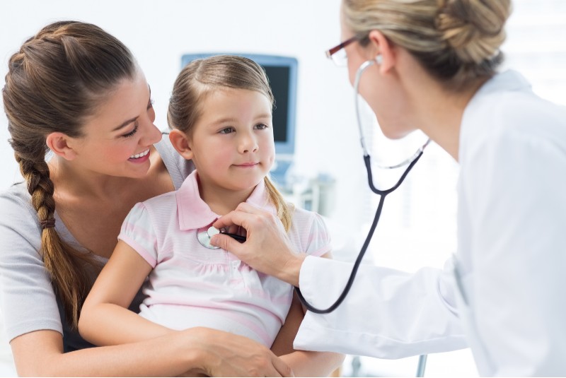 A young child at the doctors with parent. 