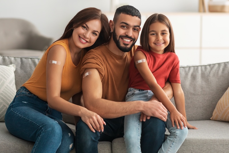 A family smiling after being vaccinated