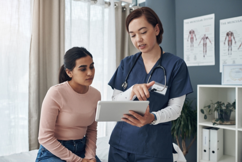 An adolescent girl is seen by a doctor