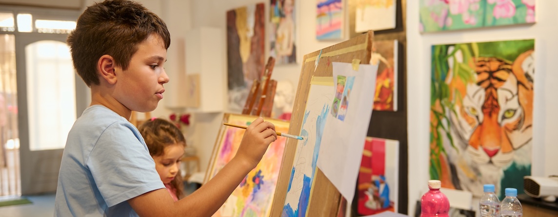 A child painting in a classroom