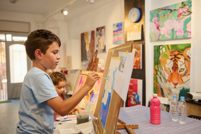 A child painting in a classroom