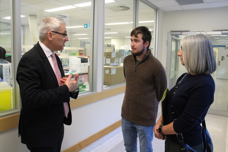 Medical Research Minister Danny Pearson speaks with leukemia patient Marco, 18, and his mother Karen