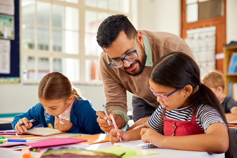 A teacher with two school children