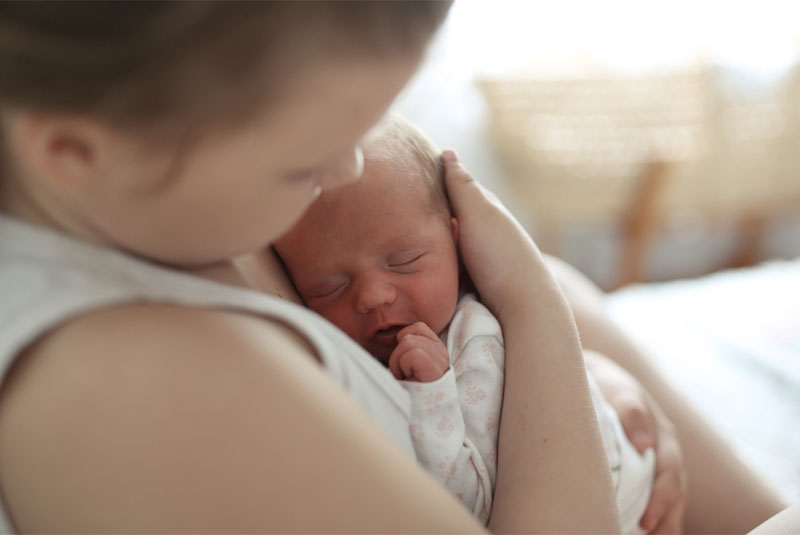 Child holding a sleeping baby