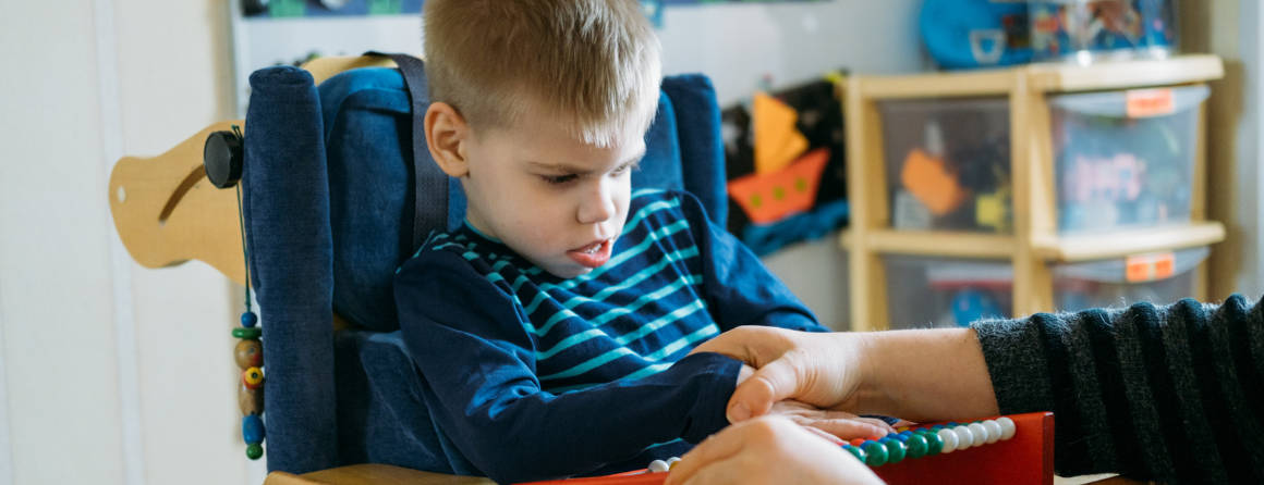 Child with disabilities learning with therapist