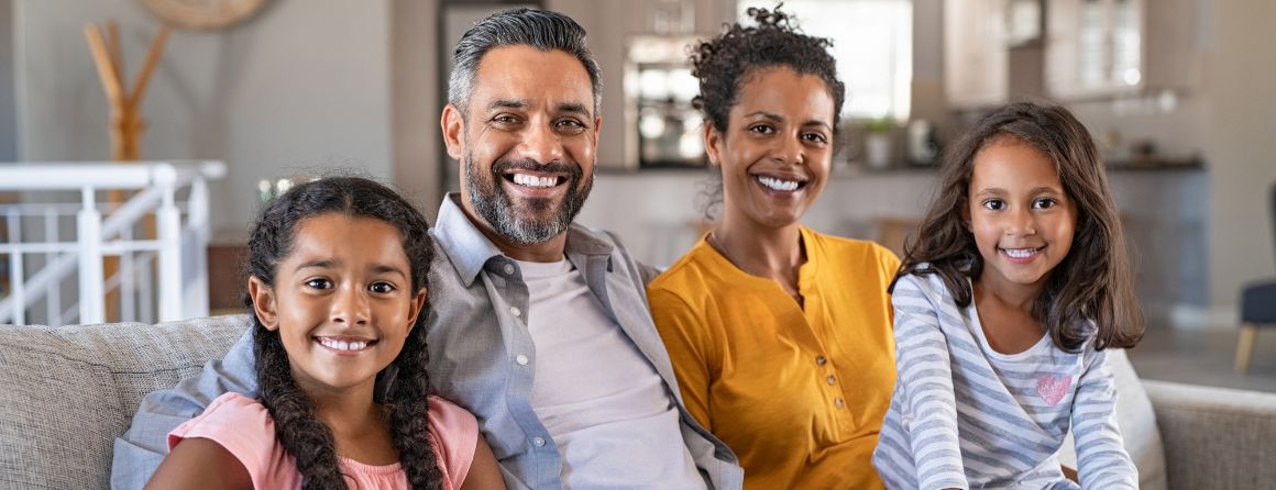 Happy indian family with their two children relaxing at home.