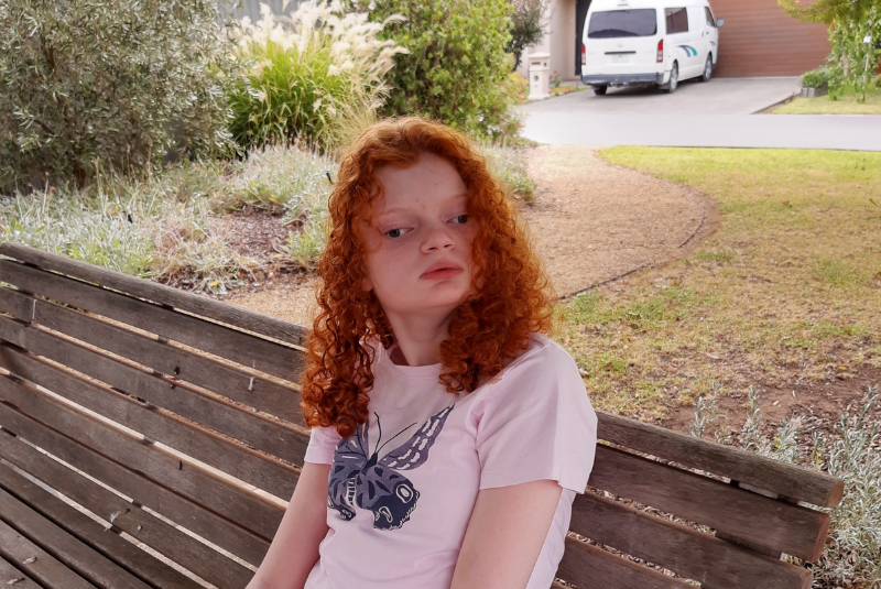 Emma sitting on a park bench