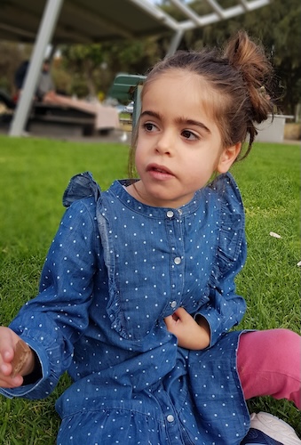 Rare disease patient Gitty sitting down outside