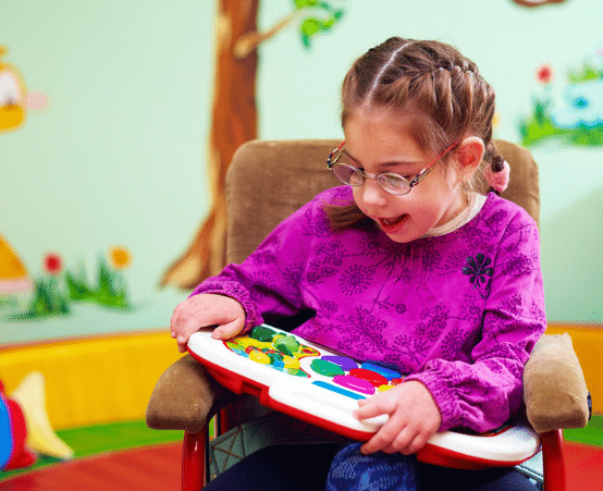 Child playing with a toy in a colourful room
