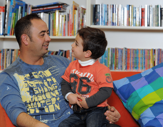 Little boy on the couch with his dad
