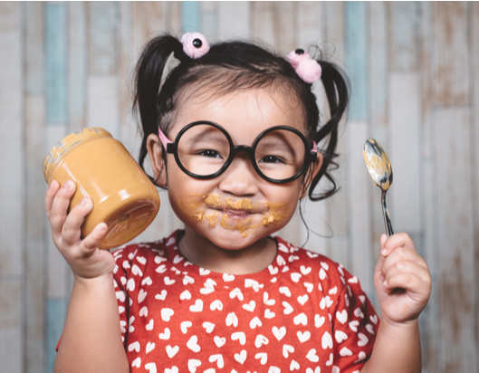 Child eating peanut butter