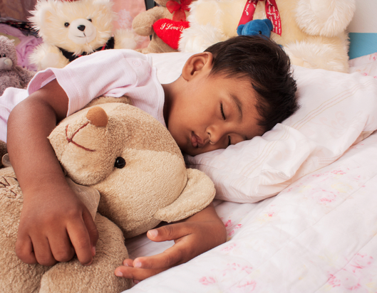 Child hugging stuffed toy