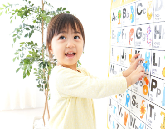 Little girl improving literacy skills at school
