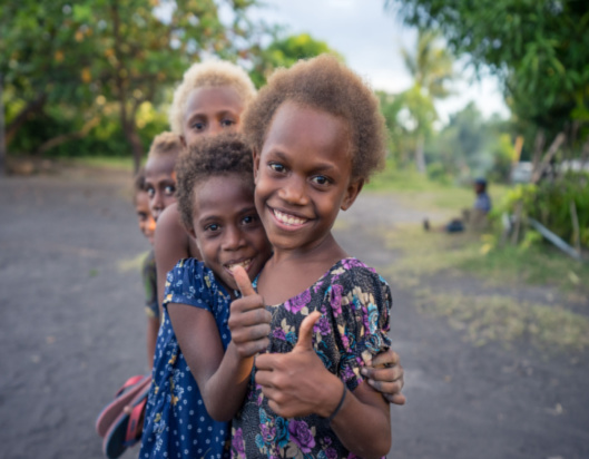 Children from Pacific region giving thumbs up