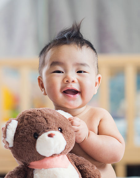 Baby holding toy