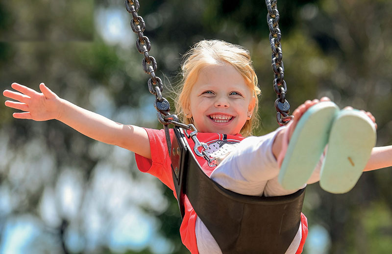 A child on a swing smiling