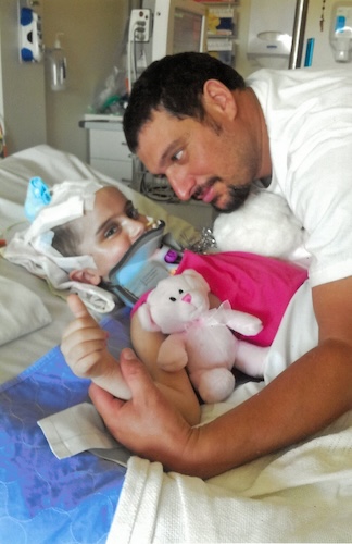 Chelsea and her father in hospital following her brain injury