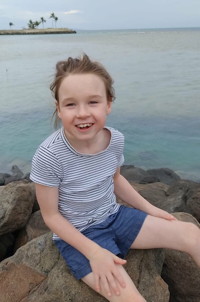 Apraxia patient Isla smiling at the beach