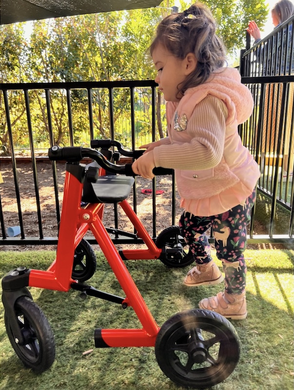 Summer, who has a Neurological disorder, with a walker