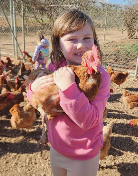 Emily holding a chicken