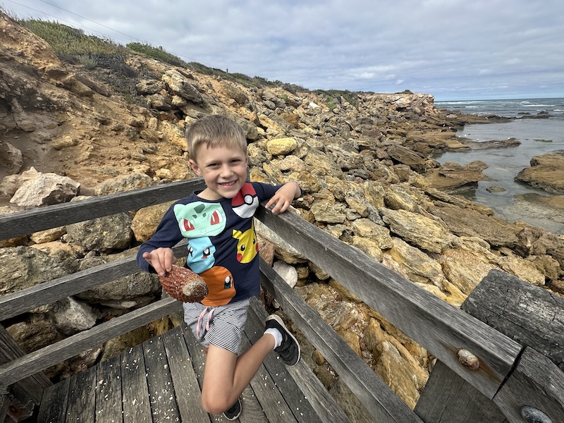 Cancer patient Oliver smiling in front of the ocean