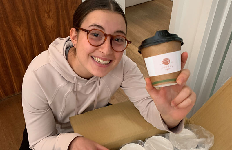 Supporter Hannah holding a coffee cup