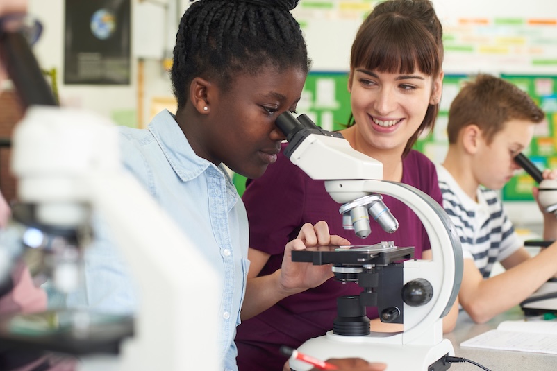A child looking through a microscope