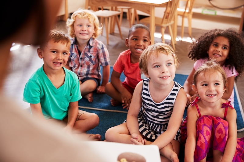 Children on a floor smiling