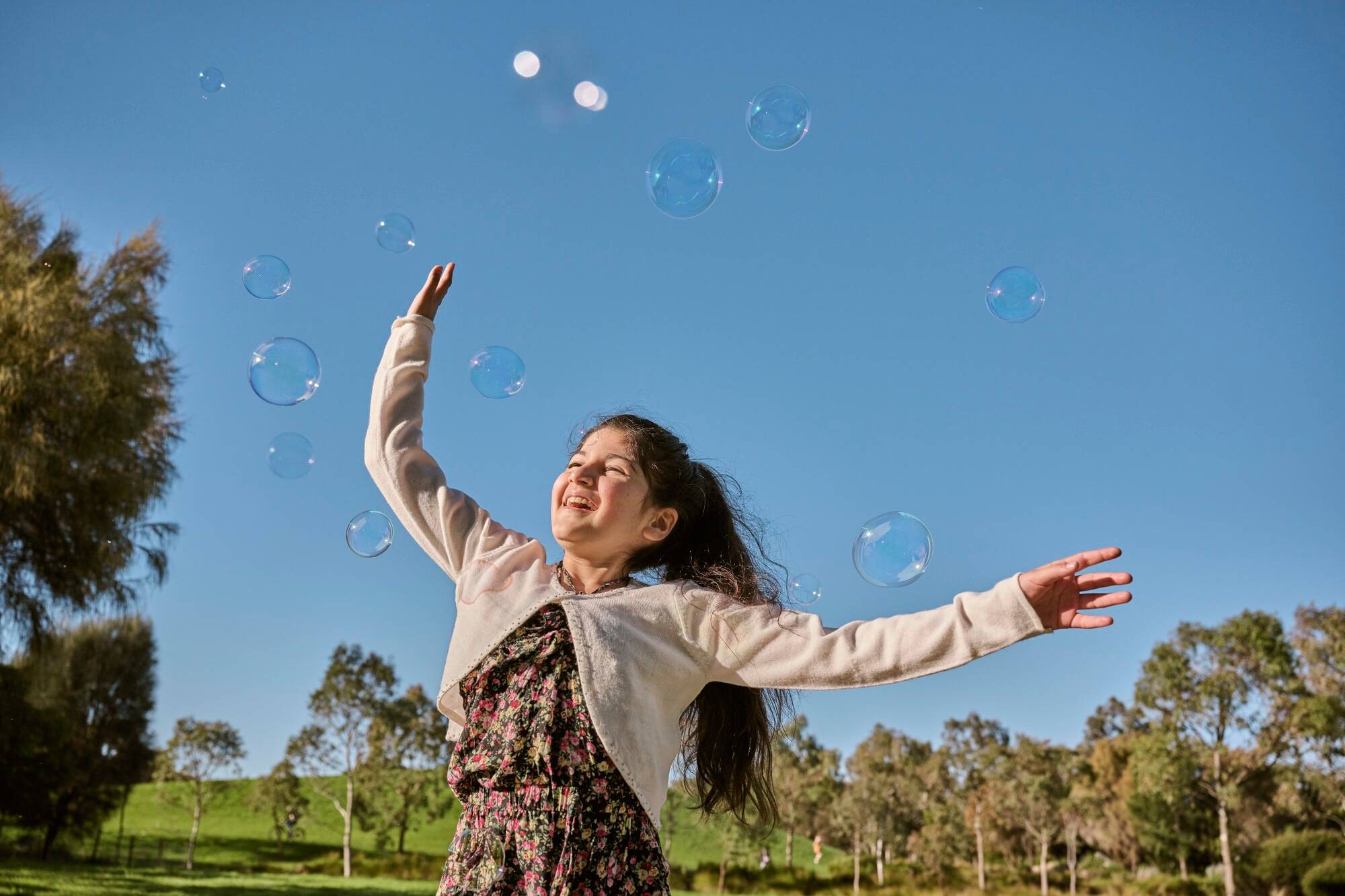 child chasing bubbles