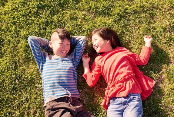 Two children looking at the sky