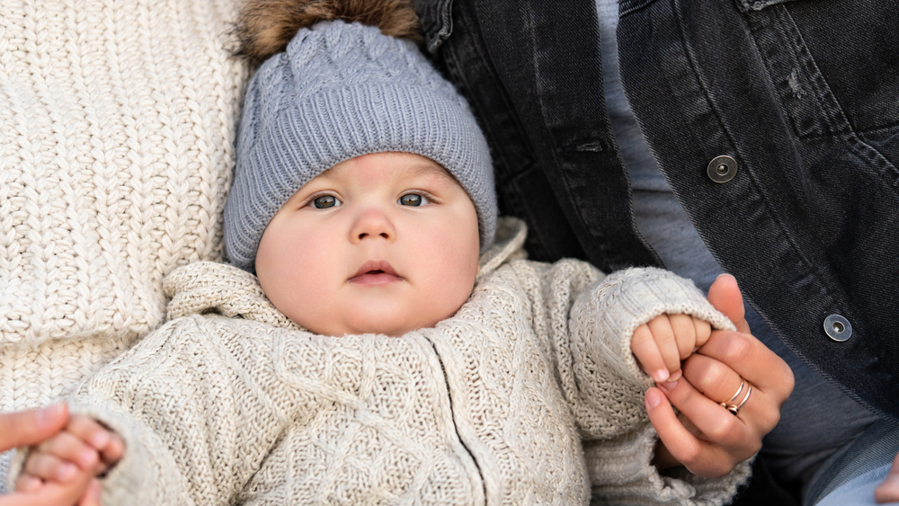 Six month old infant wearing a beanie