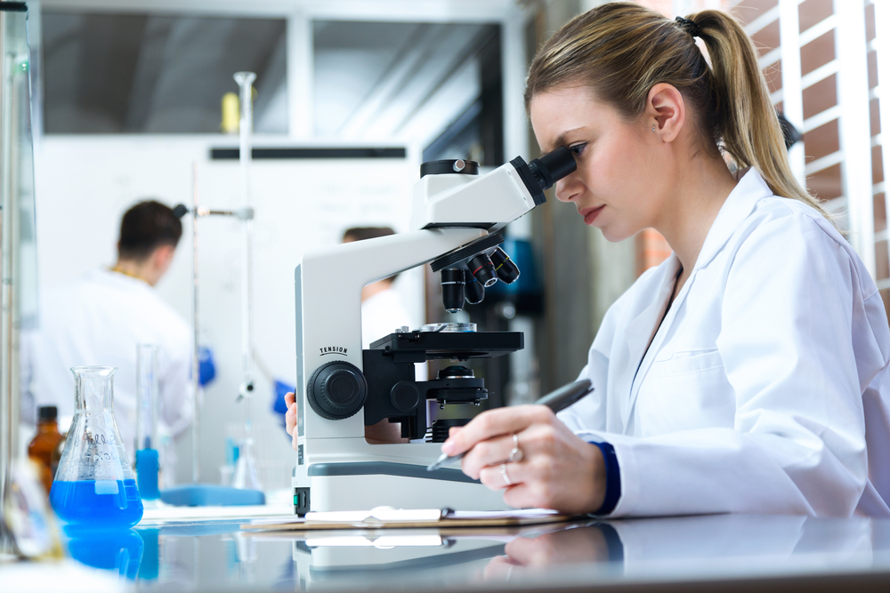 Researcher looking through microscope