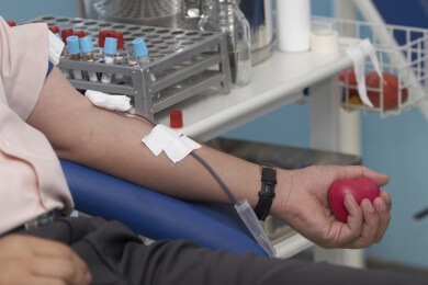 Arm of someone busy donating blood