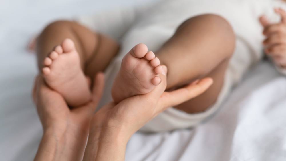 babies feet in parents' hands