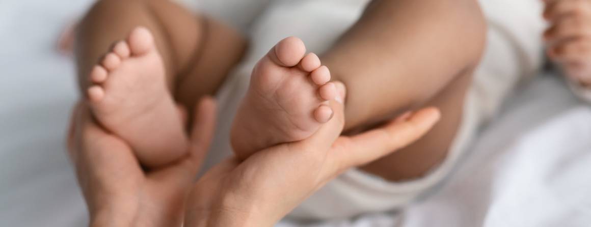 babies feet in parents' hands