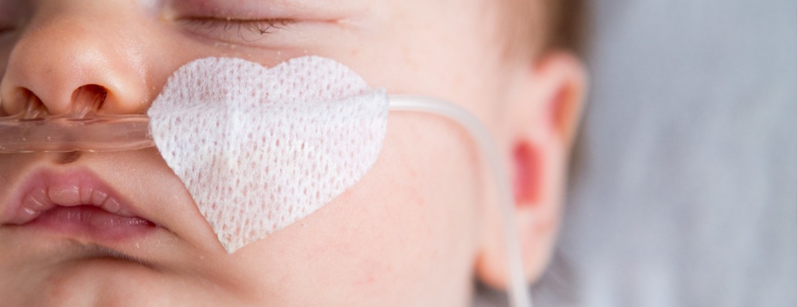Baby wearing heart shaped band aid