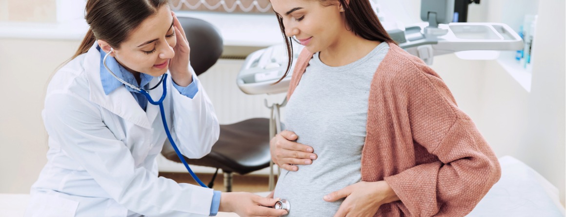 A pregnant woman is checked by a doctor