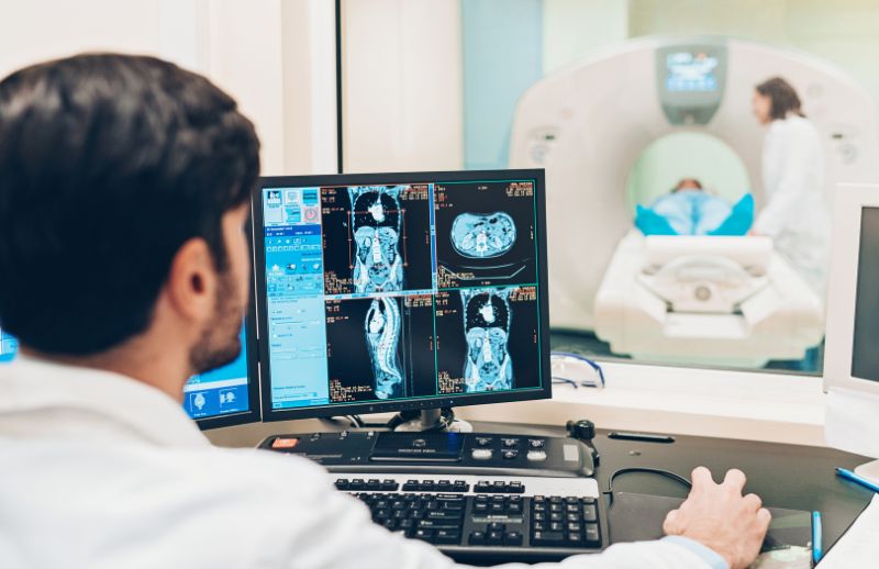 researcher looking at scans