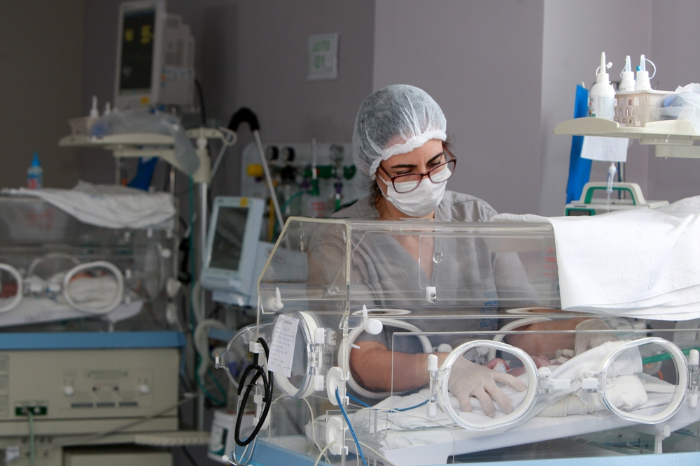 Neonatal nurse and baby in incubator