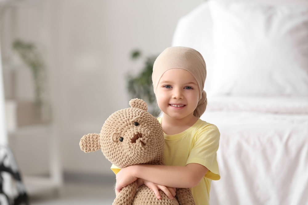 Child hugging stuffed animal and smiling