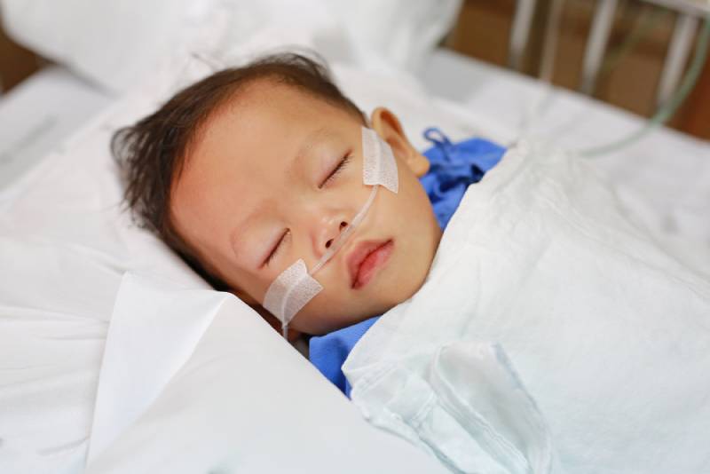 child with breathing tube