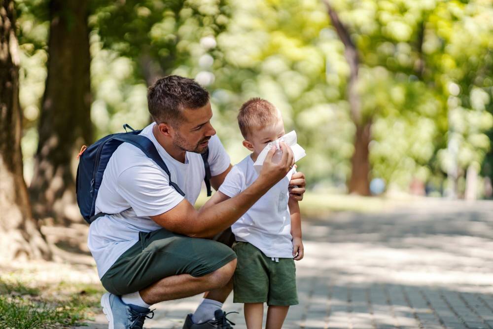 parent with child blowing nose