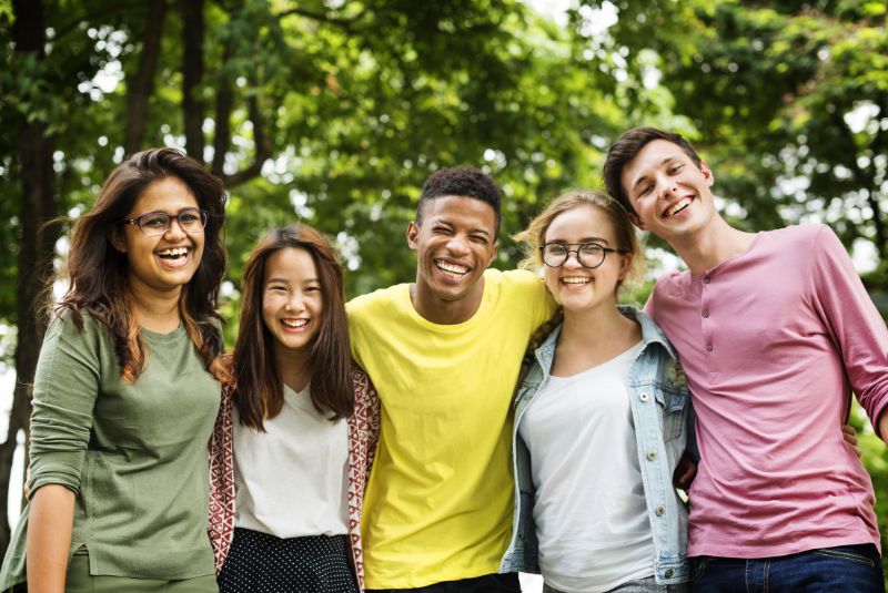 Adolescents laughing at the camera