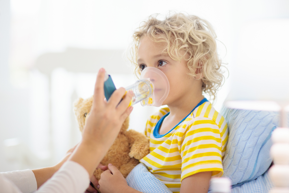 child taking asthma medication