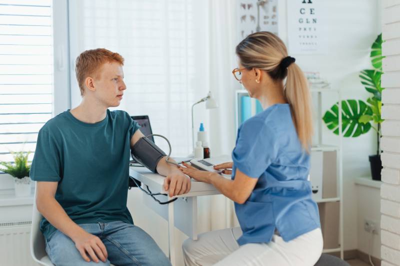 teen getting blood pressure taken