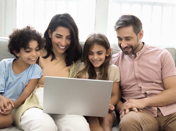 A family looking at a laptop